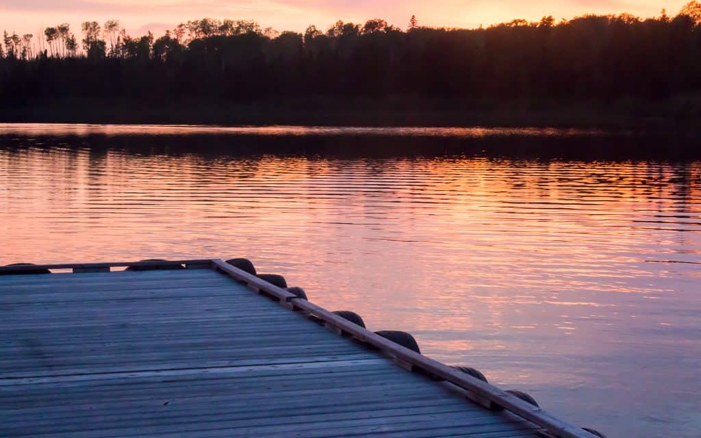 Sunset over a wooden dock on Loon Lake.